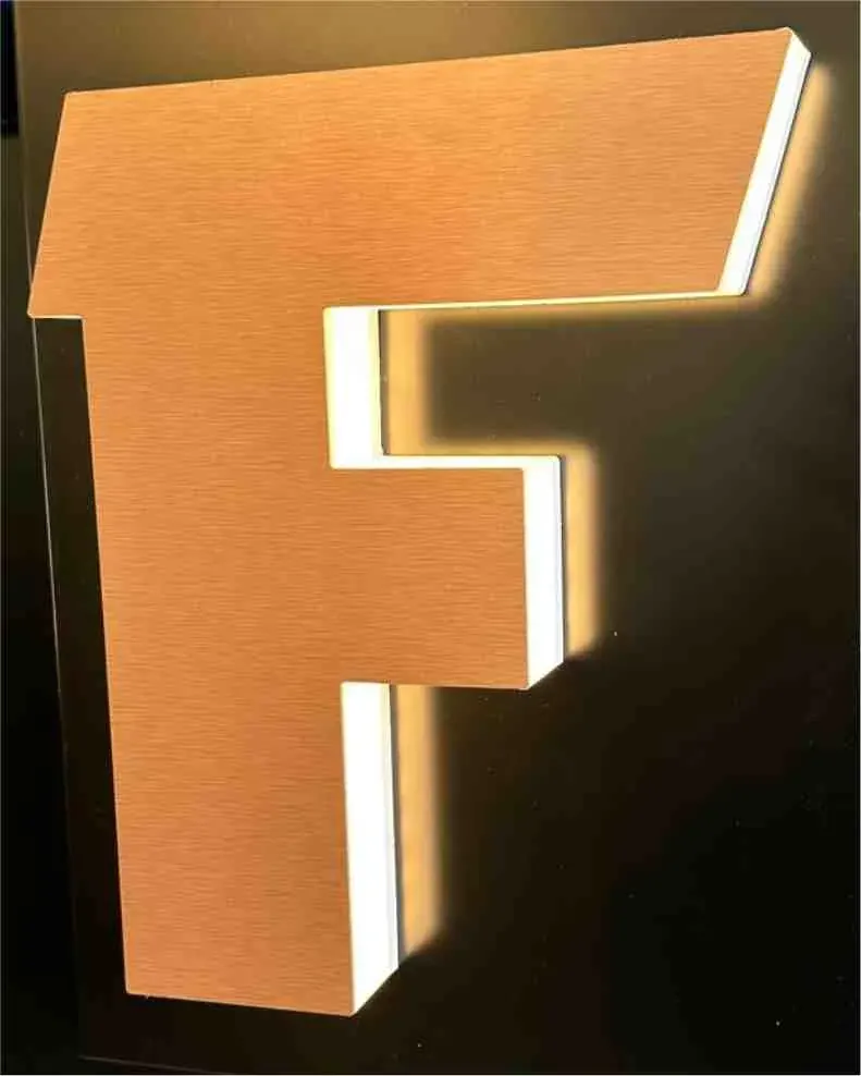 A side-lit channel letter with light glowing evenly from its translucent returns